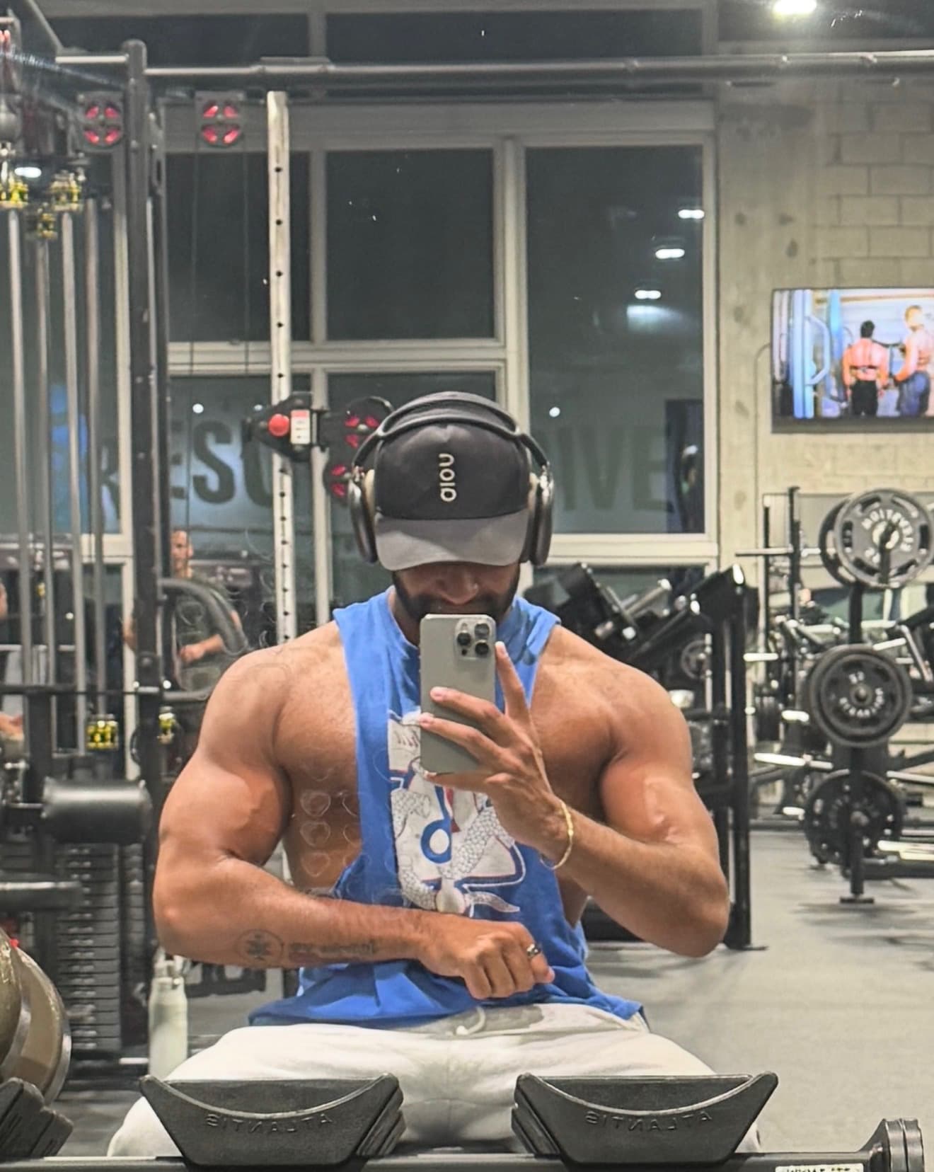 Omar in September 2026, at 197 lbs — a phone photo in a gym mirror